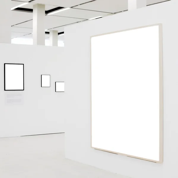 Big empty frame on white wall exhibition — Stock Photo, Image