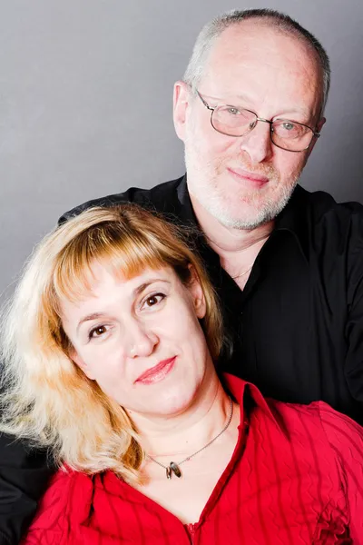 Smiling adult couple in studio — Stock Photo, Image