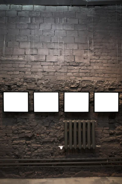 Four empty frames on brick wall — Stock Photo, Image