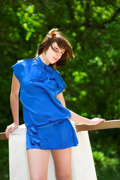 Dreaming woman in blue in park — Stock Photo, Image