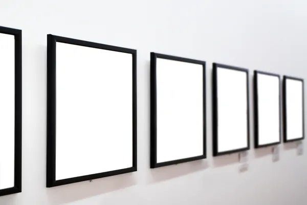 Empty frames on white wall Stock Photo