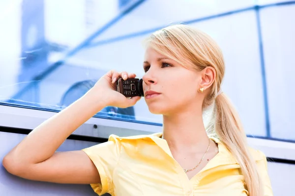 Lady in yellow talk by phone — Stock Photo, Image