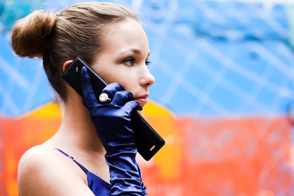 Teenager girl in blue talk by phone — Stock Photo, Image