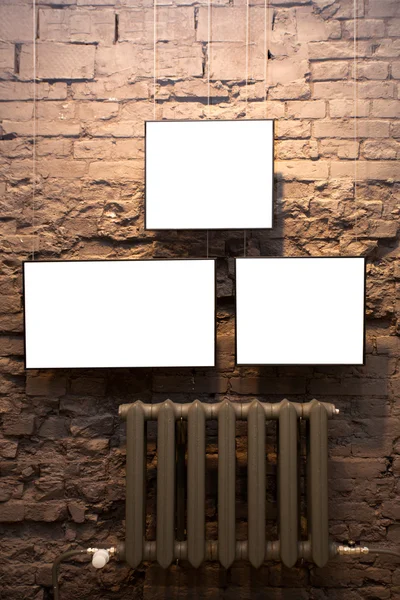 Three empty frames and radiator — Stock Photo, Image