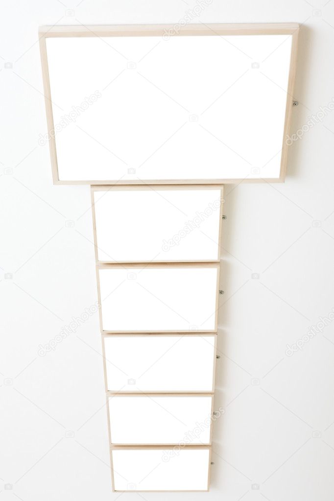 Six empty frames on white wall