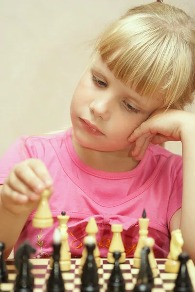 stock image The girl in a pink dress plays a chess