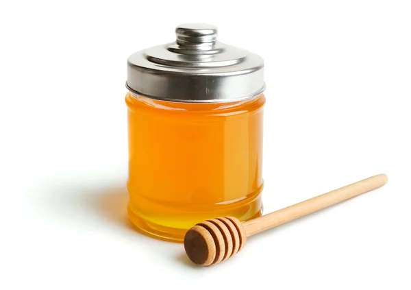 Frasco de mel e mergulhador de madeira — Fotografia de Stock
