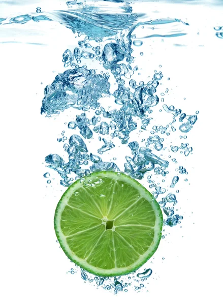 Lime slice in a water — Stock Photo, Image