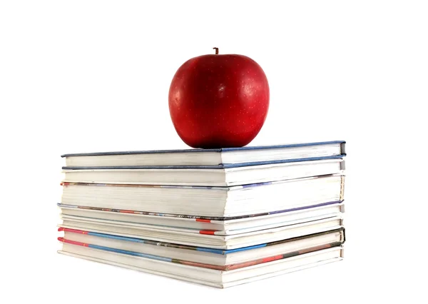 Livros didáticos com maçã sobre fundo branco — Fotografia de Stock