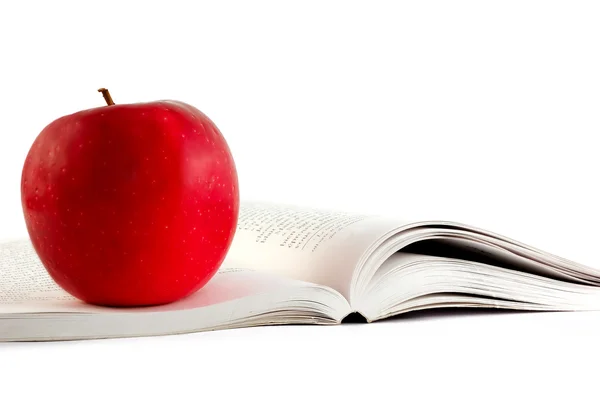 A red apple on a boo — Stock Photo, Image