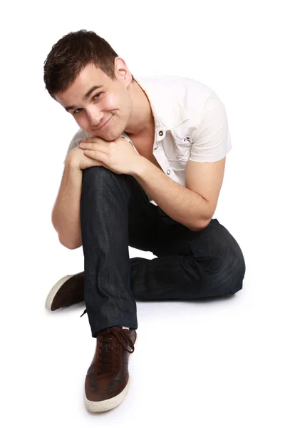 stock image Young man sitting on the floor