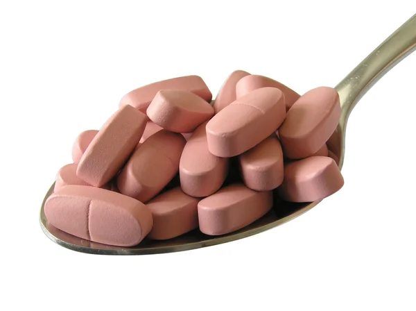 Tablety v lžíce — Stock fotografie