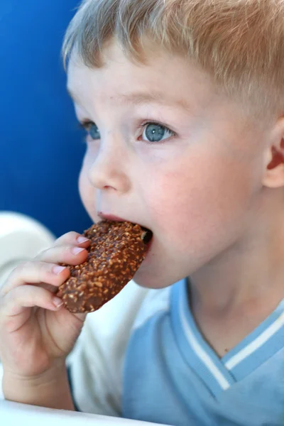Мальчик ест конфеты — стоковое фото