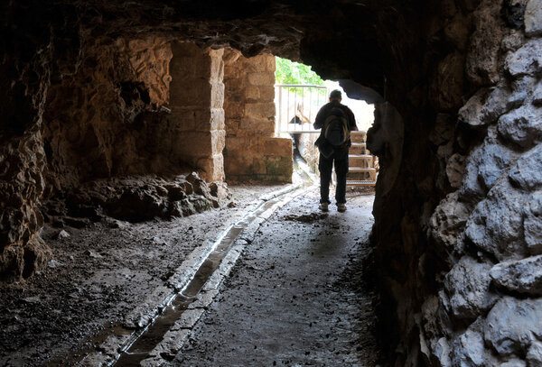 Traveller in thre underground old cave