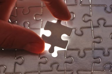 Hand placing missing puzzle piece clipart