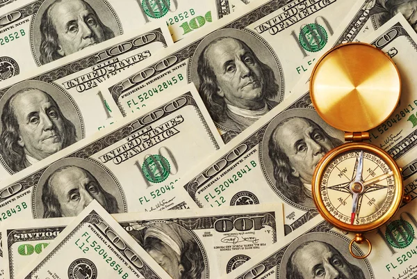 Antique compass over money — Stock Photo, Image