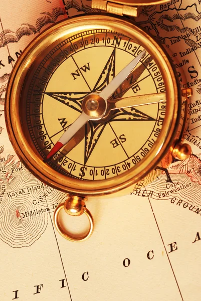 Antique brass compass over old map Stock Photo