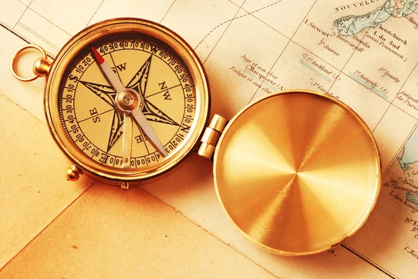 Antique brass compass over old map Stock Image
