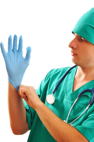 Dra på kirurgiska handskar Stockbild