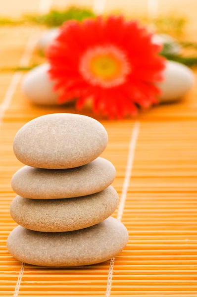 Stack of spa pebbles and flower at the b Stock Photo