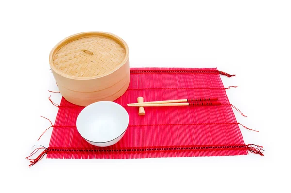 Chopsticks and bowl on the bamboo mat — Stock Photo, Image