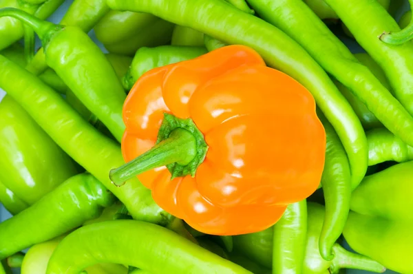 Orange bell pepper and green peppers — Stock Photo, Image