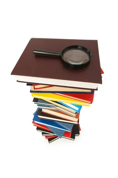 Magnifying glass over the books — Stock Photo, Image