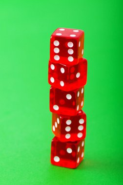 Red dice against green background clipart