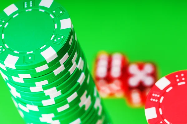 Casino chips and dice against green — Stok Foto
