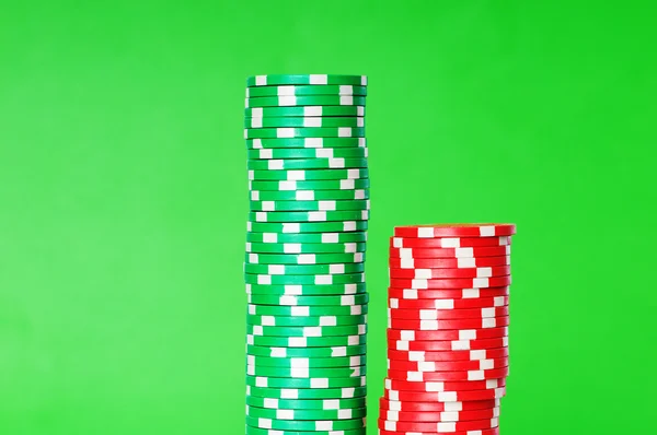 Stack of casino chips against green — Stock Photo, Image