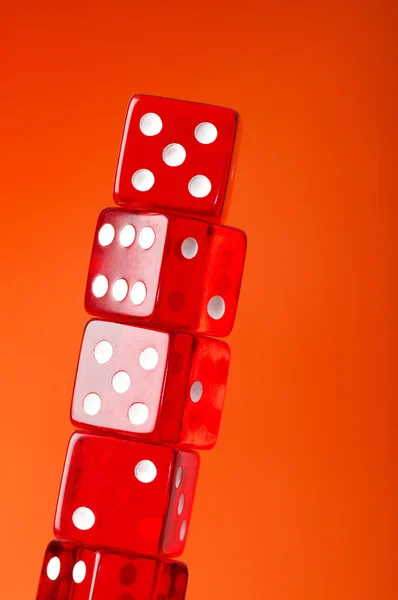 Red dice stack against blurred green — Stock Photo, Image