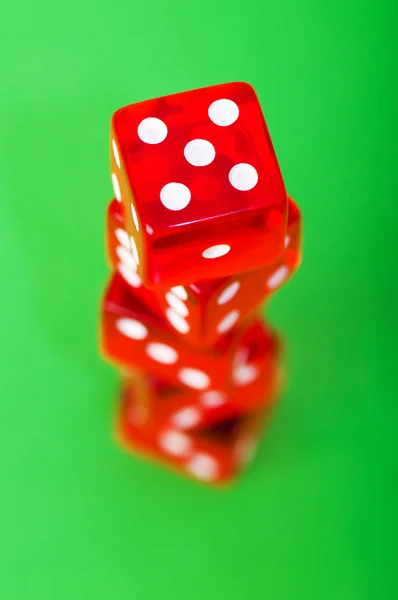 Red dice against green background — Stock Photo, Image