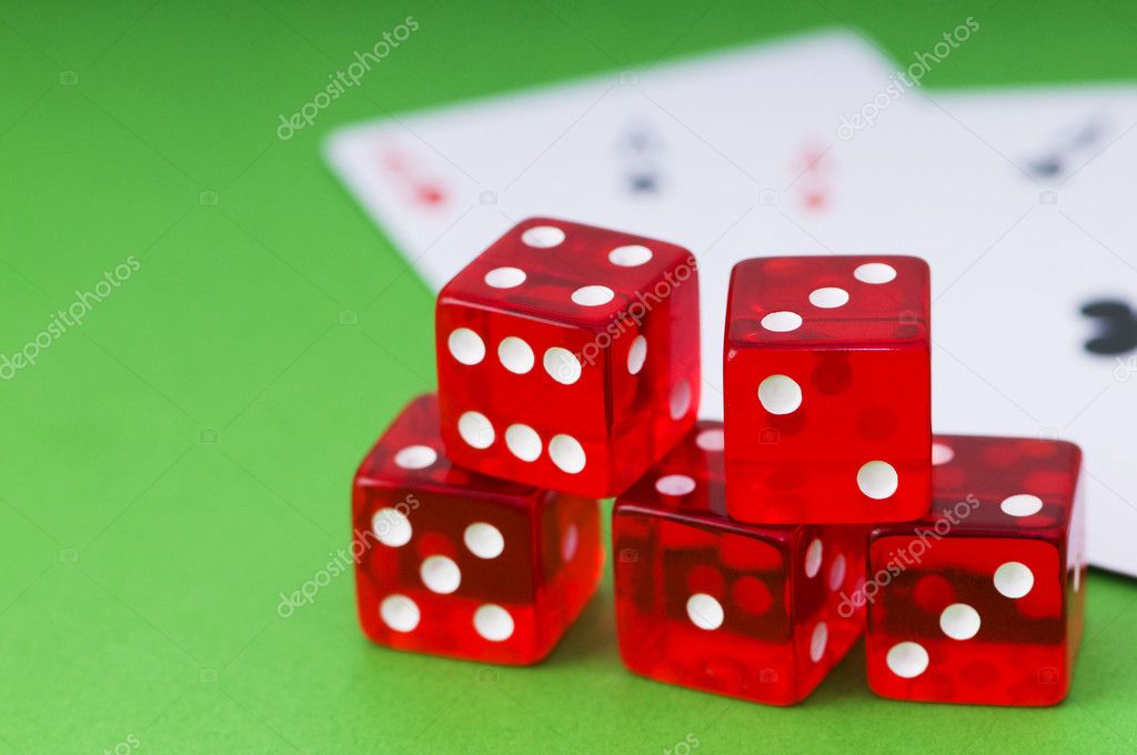 Red dice and cards at the green