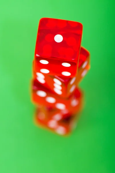 Red dice against green background — Stock Photo, Image