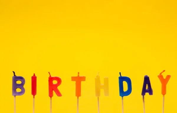 Happy birthday isolated on the yellow — Stock Photo, Image