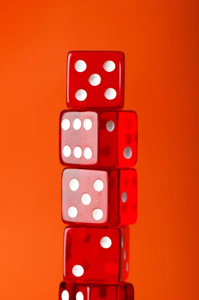 Red dice stack against orange — Stock Photo, Image