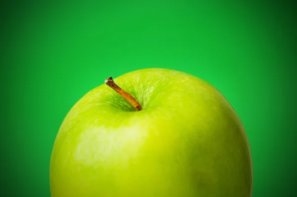Green apple against green — Stock Photo, Image