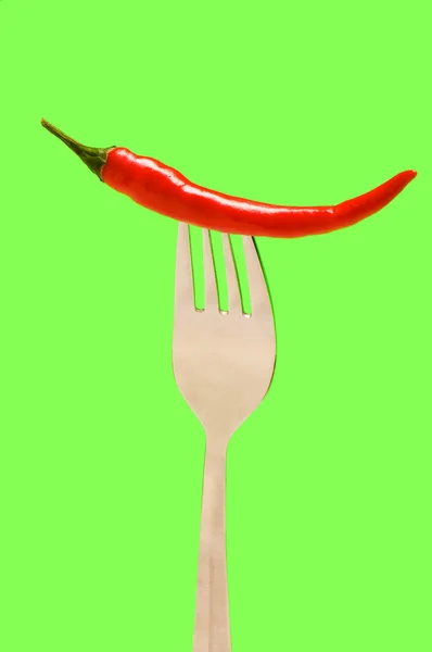 Red pepper isolated on the green — Stock Photo, Image