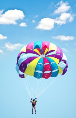 Multi coloured parachute over the sky clipart