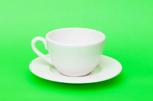 White tea cup isolated on green — Stock Photo, Image