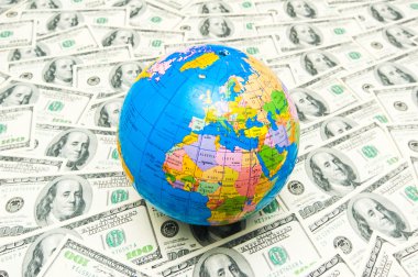 Globe over many american dollars clipart