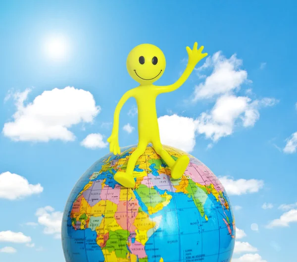 Smilie sitting on the glob — Stock Photo, Image