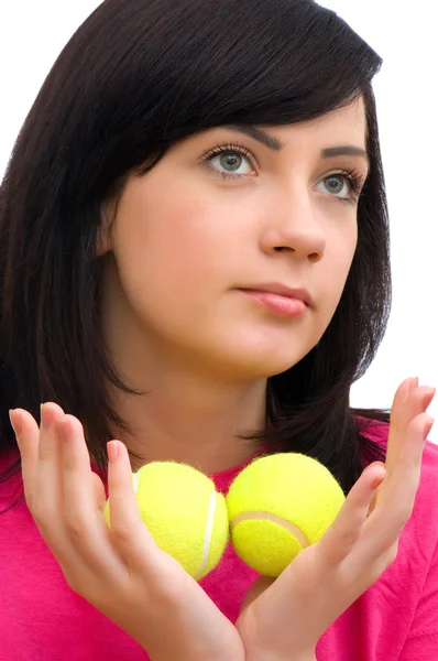 Menina segurando duas bolas de tênis no branco — Fotografia de Stock