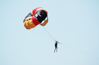 Multi coloured parachute over the sky clipart