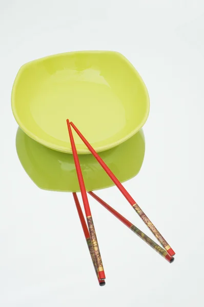 Red plate and chopsticks — Stock Photo, Image