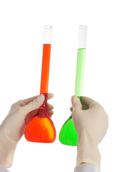 Hand holding red and green tubes — Stock Photo, Image