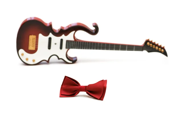 Red bow tie and guitar isolated — Stock Photo, Image