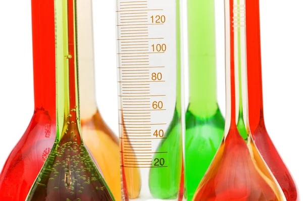 Measuring glass and coloured retorts — Stock Photo, Image