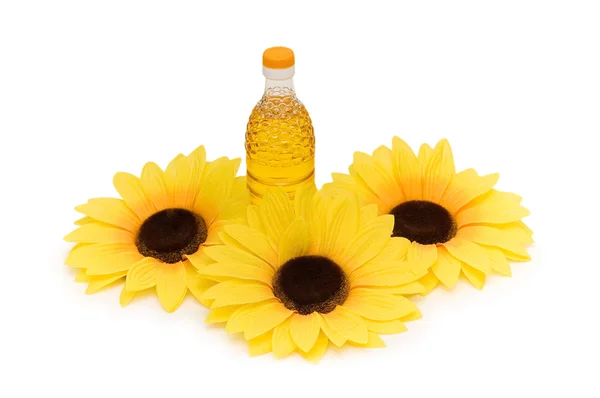 Three sunflowers and bottle of oil — Stock Photo, Image