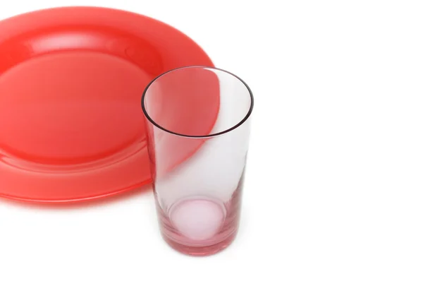 Röd tallrik och glas isolerade — Stockfoto